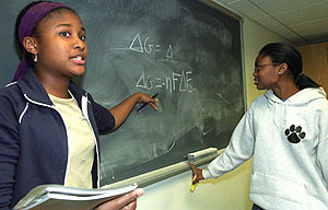 Imani Anwisye (left) mentors freshman Sylvia Lee in a chemistry study group at Cornerstone: The Center for Advanced Learning, where Anwisye serves as an academic mentor in chemistry.