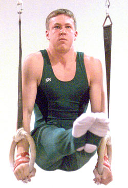David Ader, who was on the University's club gymnastics team as a freshman, shows off his form on the rings. He would later focus more on student government, but he became a children's coach at the St. Louis Gymnastics Centre.
