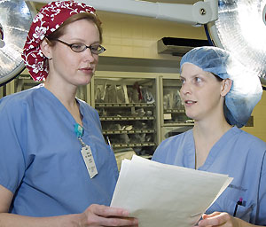 Amber Traugott (right) and Andrea Van Pelt, M.D., a plastic surgery resident, talk in the operating room about a future case. One of Traugott's professors, Timothy G. Buchman, M.D., Ph.D., the Harry Edison Professor of Surgery, professor of anesthesiology and of medicine, says of Traugott, 