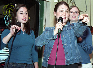 Sasha E. Polonsky (center) of the School of Law hams it up as she and classmates Anne Andrews (left) and Cindy Ricks sing karaoke at a local nightspot. But don't think Polonsky is all fun and games.