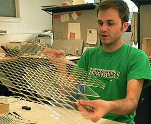 Survant works in Givens Hall with a model.