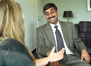 Mahendra Gupta, Ph.D., dean of the Olin School of Business and the Geraldine J. and Robert L. Virgil Professor of Accounting and Management, enjoys a laugh with student Marla R. Rappaport in his office.