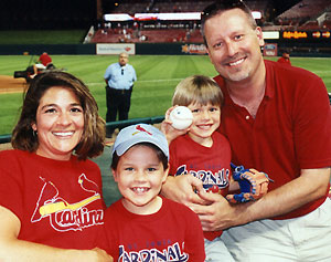 Toni, Adina (7), Eric (4) and Richard Loomis take in a Cardinals game at Busch Stadium.