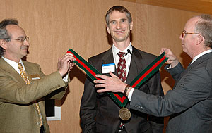Gruia-Catalin Roman, Ph.D. (left), chair of the Department of Computer Science and Engineering and the Harold B. and Adelaide G. Welge Professor of Computer Science, and William P. Darby, Ph.D., vice dean of academic affairs and dean of the University of Missouri-St. Louis/Washington University Joint Undergraduate Engineering Program, present Michael R. Brent, Ph.D., with the Henry Edwin Sever Professor of Engineering medal in a recent ceremony.