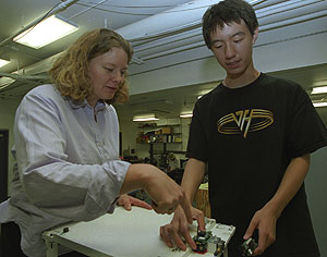 Shirley J. Dyke, Ph.D., and Pengcheng Wang work in Dyke's earthquake engineering lab in the Students and Teachers as Research Scientists (STARS) program for gifted high-school students.