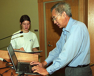 Rebecca Rivard, a senior at Clayton High School, observes Frank C.P. Yin, M.D., Ph.D., as he prepares a lecture for some 60 STARS students and their mentors July 5 at the Whitaker Auditorium.
