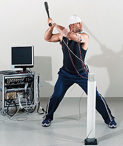 Albert Pujols prepares to swing a bat in the lab of Catherine Lang, Ph.D., assistant professor of physical therapy, neurology and occupational therapy.