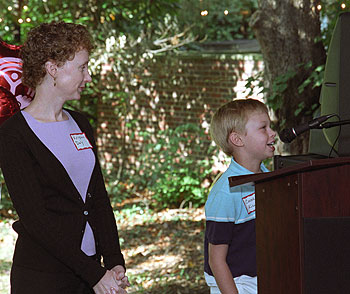 Conor Killen, 9, whose leukemia is now in remission, takes the podium while his mom looks on. Conor is the son of Dirk Killen, Ph.D., assistant dean in the College of Arts & Sciences and academic integrity officer, and his wife, Kristin Daly (above).