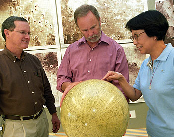 From left, WUSTL scientists Bradley Joliff, Ph.D., Raymond Arvidson, Ph.D., and Alian Wang, Ph.D., observe the giant South Pole-Aitken Basin on the moon.