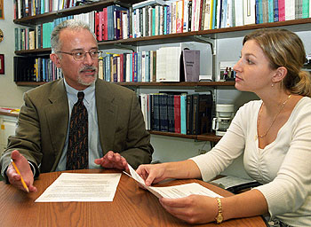 Luis Zayas confers with Allyson Pilat, project assistant at the Center for Latino Family Research. 