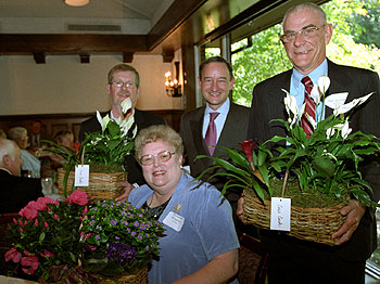 Chancellor Mark S. Wrighton stands with (from left) Donald Davis, Suzanne Winkler and Bill Smith at a luncheon honoring those who retired from the University in 2006.