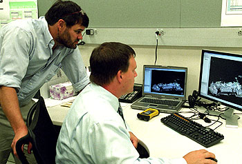 Aaron Addison (seated), University GIS coordinator in the Network Technology Services office, and T.R. Kidder, Ph.D., professor of anthropology in Arts & Sciences, look at a LIDAR (Light Detection and Ranging) building rendering. LIDAR is a laser-imaging technique that supplies data that can be manipulated in three dimensions. It is often used with GIS to enable dramatic high-resolution imaging and analysis.