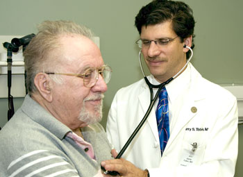 Garry Tobin, M.D., examines Koule Bude, who has type 2 diabetes, in the Washington University Diabetes Center at Barnes-Jewish Hospital.