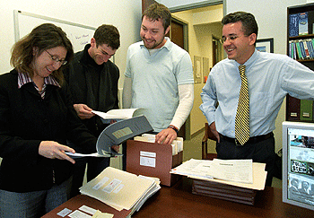 A leading authority on prisons and inmate litigation, Margo Schlanger, J.D., (left), professor of law,  teamed with colleagues and students to create an electronic library of documents related to civil rights injunctive cases. Pictured with Schlanger are (from left) law students Josh Altman and Greg Venker, and Troy DeArmitt, research technologist for the Center for Empirical Research in the Law.