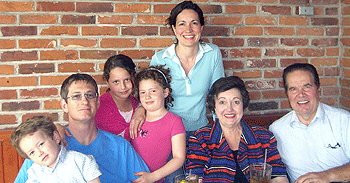 (From left) Son Erik (4), husband Michael Tomasson, daughters Julia (10) and Helen (8) and Katherine Weilbaecher share dinner with Weilbaecher's parents, Sharon Nelson Weilbaecher and Bob Weilbaecher.