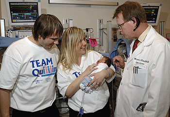 (From left) Pete and Jenny Ferrill of Danville, Ill., hold Kieran, one of their quintuplets born Dec. 21 at Barnes-Jewish Hospital, and talk with Michael Paul, M.D., the physician who delivered the quints — the first set ever at Barnes-Jewish Hospital. The Ferrills had three boys and two girls.