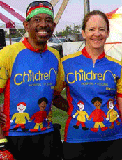 Dee Hodge and his wife, Ann Petlin, enjoy a break during a bike ride and show off their St. Louis Children's Hospital jerseys.
