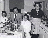 Alex Denes and his twin brother, Bela, with their parents, Lajos and Kato, at their home in Belleville, Ill., in the late 1950s shortly after they immigrated to the United States.