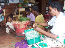 Women from Mahabo Village in Madagascar weaving baskets for the Blessing Basket Project.