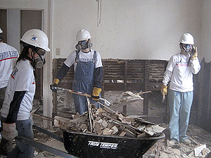 Physical therapy doctoral students (from left) Lesley Sunoo, Jeanette May and Shannon Hoffman gut a New Orleans home damaged by Hurricane Katrina on their spring break service trip.