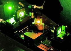 A laser beam makes its way through a maze of mirrors and positioning equipment that pinpoint light for use in optical imaging.