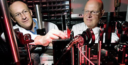 Joseph Culver, PhD, left, and Michael Welch, PhD, examine a state-of-the-art diffuse optical tomography system at Washington University. The system allows researchers to visualize tumors and assess functional status in small animal models without the use