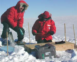 Douglas Wiens (left) and a colleague ready equipment to emplace seismographs in Antarctica during a 2001 expedition.  Data gathered for this project, called TAMSEIS, provided evidence that an Antarctic ice stream radiates seismic waves twice daily that are equivalent to a magnitude 7 earthquake.