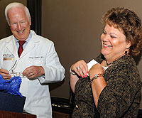 Tina Grubbs, office coordinator for the Department of Surgery, expresses delight in receiving the Dean's Distinguished Service Award from Larry J. Shapiro, M.D., executive vice chancellor for medical affairs and dean of the School of Medicine, June 17. The award, considered to be the medical school's highest form of staff recognition, recognizes employees who exceed their job responsibilities, help to create a positive working environment and improve the community in which they live.