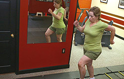 Maria Littrell works out at Lionheart Fitness in Richmond Heights. Littrell, who lost weight through gastric bypass surgery, does strength training and cardio exercise twice a week.