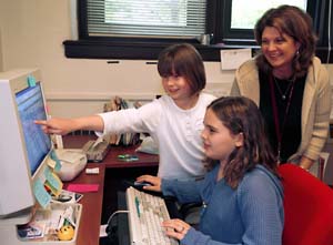 Daughters play on the office computer during