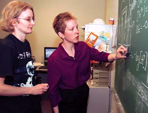 Frey discusses chemical equations with Carolyn Jones Otten