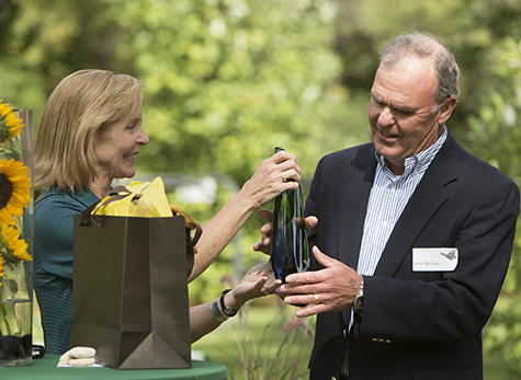 Lee Ann Quatro presents vase to Kent Theiling landscape design manager
