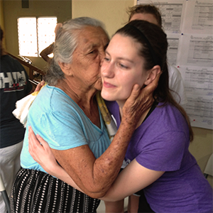 Physical therapy student Leslie Wallace gets a kiss from a Guatemalan woman who was grateful for the students' visit to her village. 