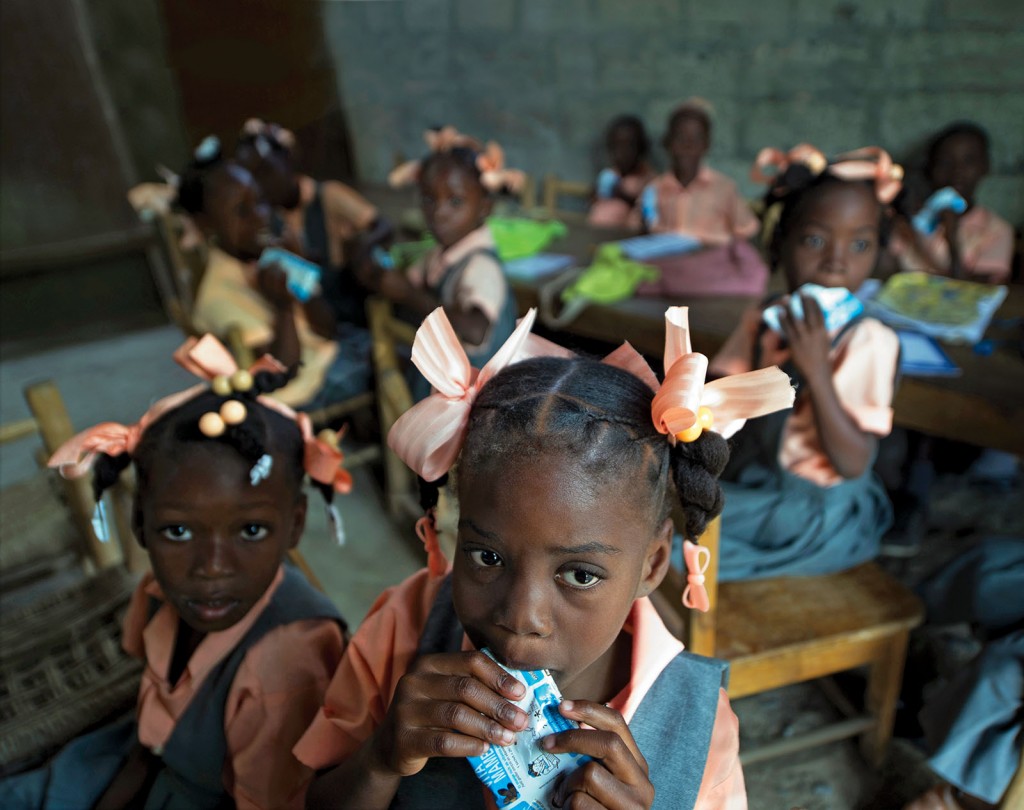 In Haiti, Brown School Assistant Professor Lora Iannotti, PhD, also partners with Patricia Wolff, MD, professor emerita of clinical pediatrics at the medical school, to develop and distribute Vita Mamba, a fortified snack for impoverished school-age children. Research shows significant improvements in the body composition of children receiving the supplemental snack. (Photo: Hector Retamal/Agence France-Presse)