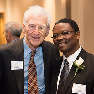 Washington University Chancellor Emeritus William H. Danforth (left) visits with Samuel Achilefu, PhD, after Achilefu received the St. Louis Award on Wednesday, Jan. 14, on the Medical Campus. The honor recognizes area residents whose achievements reflect positively on the community. Danforth received the honor in 2012.