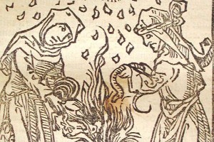 Old illustration of two witches by a fire.