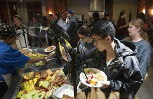 students walk through a breakfast buffet