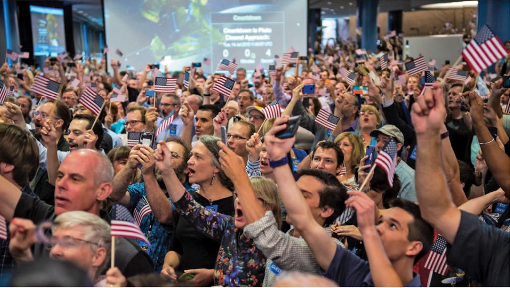 The moment of ­closest approach to Pluto on the morning of July 14, when radio silence prevailed, but New Horizons team members and guests at the Applied Physics ­Laboratory hoped all was well. (Photo: NASA/Bill Ingalls)