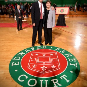 man and woman stand on basketball court