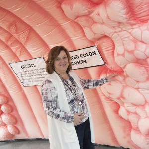 woman walks through inflatable colon display