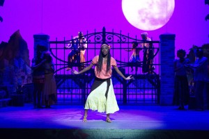 A woman stands on stage.