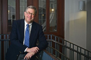 man in suit smiles at camera