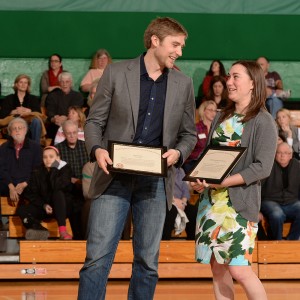 man and woman holding plaques