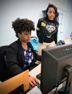 Waddles (left) is one of five Washington University graduates working full time in St. Louis schools. (Photo: James Byard/Washington University) 