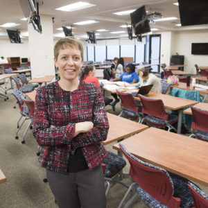 woman stands in classroom