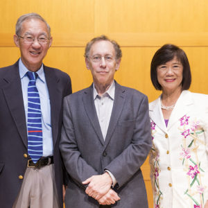 three people pose for a photo