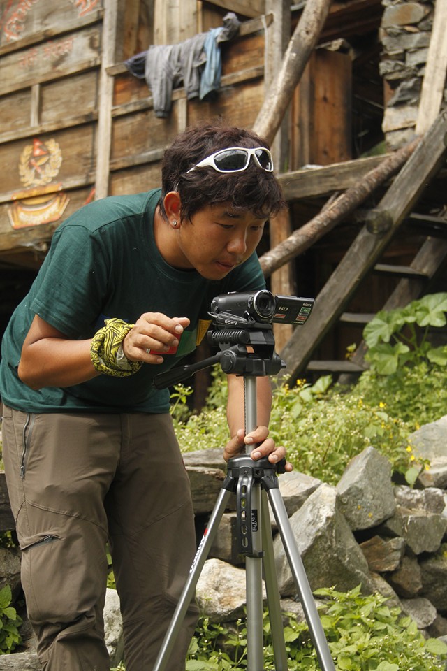 Nubri team member Nyima Samdrub preparing to video record an interview with an earthquake survivor.