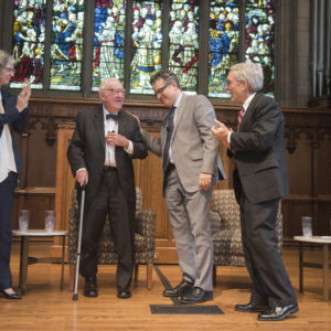 four people standing at front of Graham Chapel