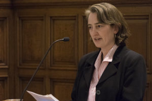 woman speaks at a lectern