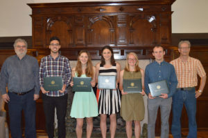 students with certificates smile for a photo